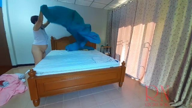 Nudist housekeeper Regina Noir makes bedding bedroom. Naked maid. Naked housewife.