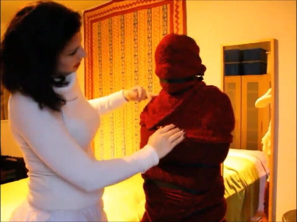 Mummified, bound and cuddled by woman