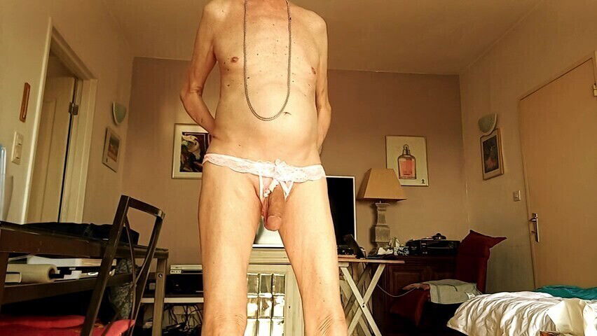 nude wearing a pink string with pearls