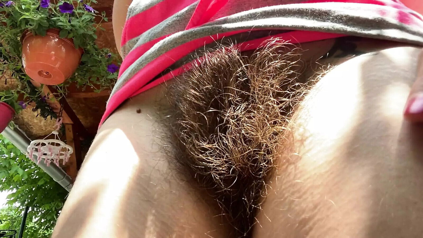 Smoking cigarettes outside closeup hairy bush