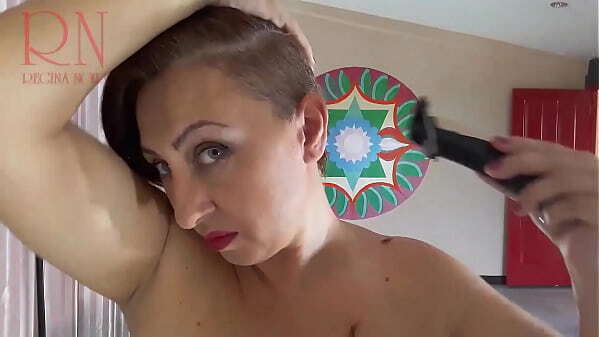 Naked nudist hairdresser. Stylist cuts hair. Regina Noir