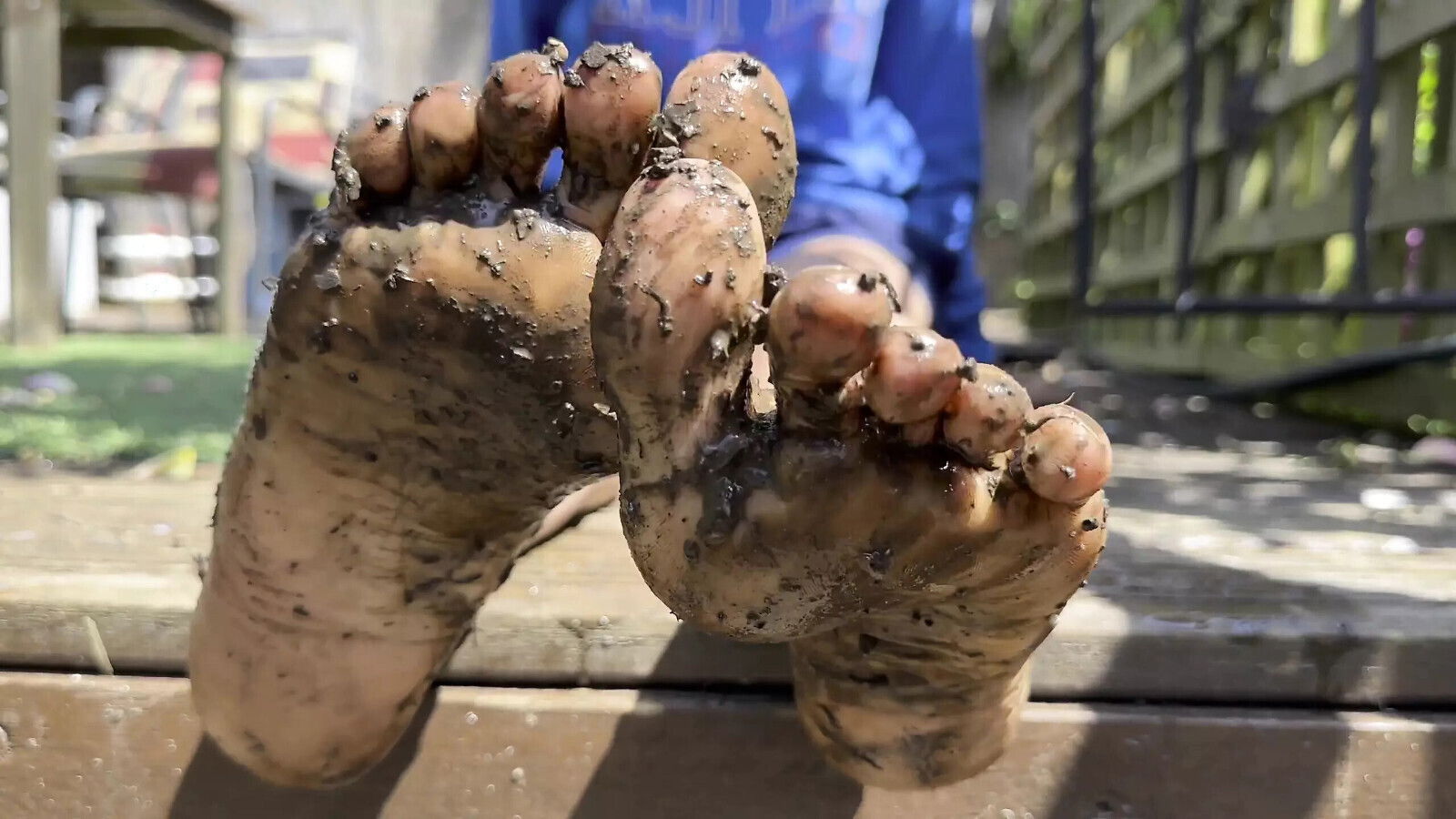 Muddy Soles playing with between toes back garden