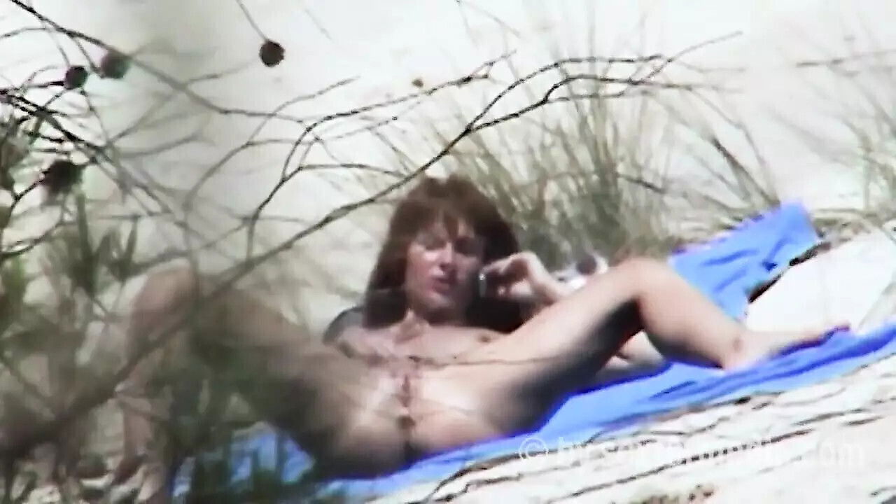 Redhead beauty dildoing pussy sandy beach