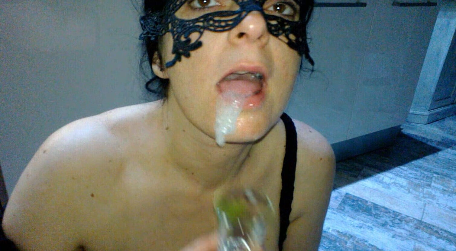 milf sucks with artificial open mouth lips. After getting sperm mouth, plays with cup.