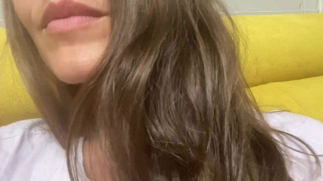 Women watch shiny dark hair play with them. Close view