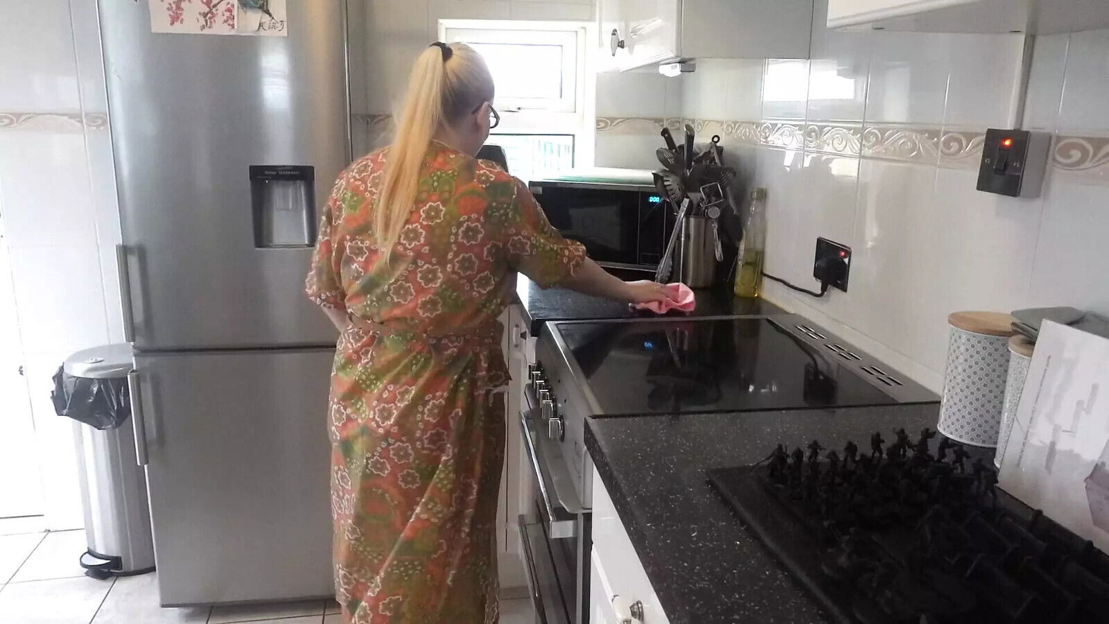 Naughty housewife cleaning kitchen