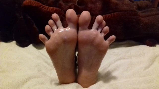 Rubbing into feet spreading toes