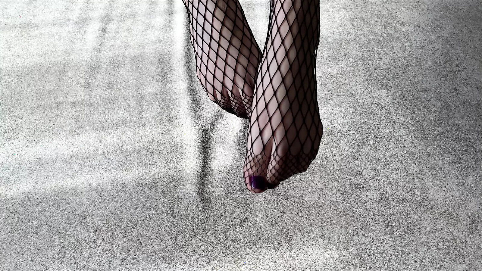 Girl black fishnet pantyhose caresses legs