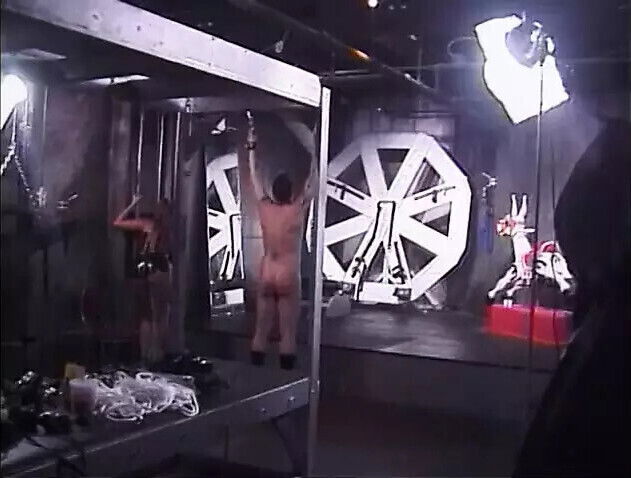 Dominatrix grabs bound slaves