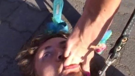 Leashed slave licking mistresses bare feet after pony play outdoors