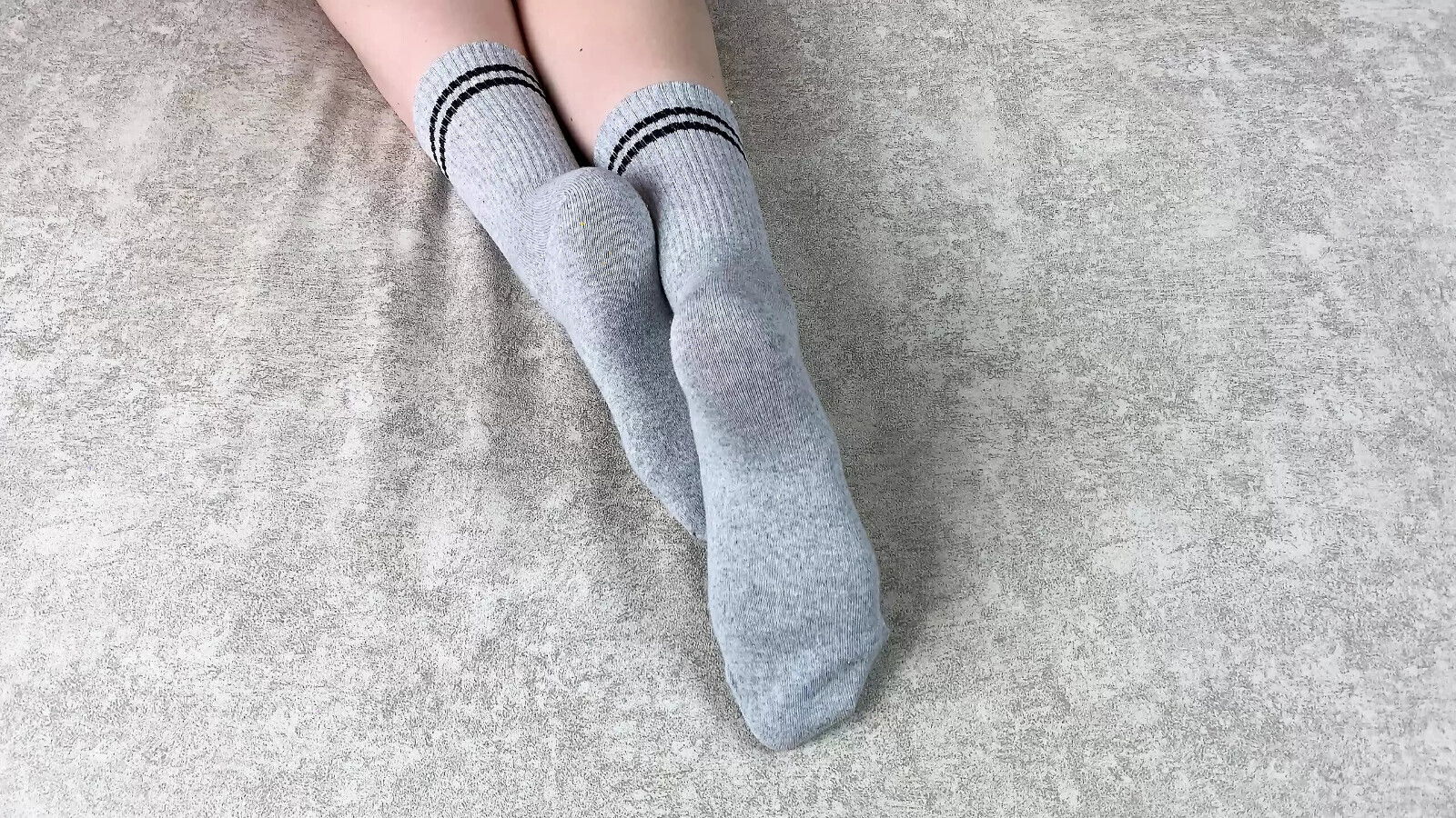 Girl strokes legs gray cotton socks